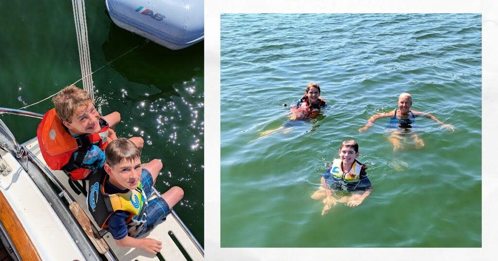 boys in life jackets on swim platform of boat, grandma and grandsons swimming in lake erie
