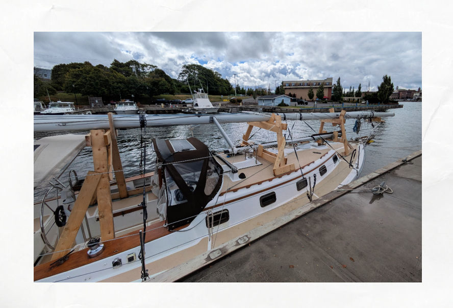 sailboat tied to wall with mast down 