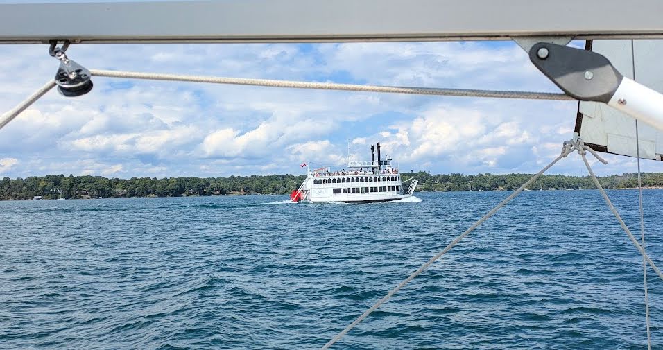 tour paddleboat passing by sailboat in The Thousand Islands 
