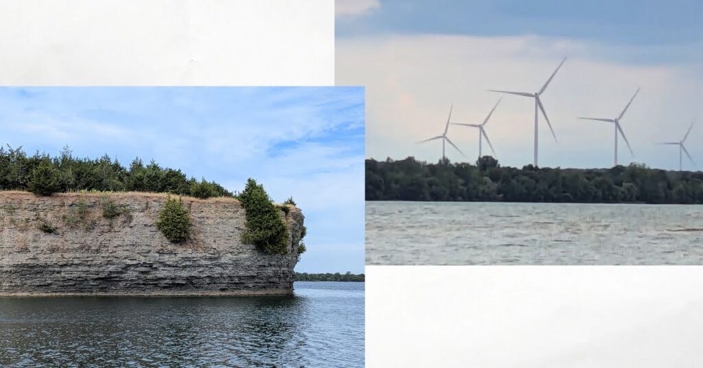 windmills on shore, shoreline tall bluff with trees 